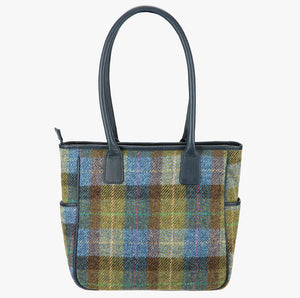This is the reverse of the Harris Tweed tote bag in blue, green and brown check with handles that go over the shoulder. This bag is denim sage Harris Tweed with navy blue leather handles. It has a pocket on each side of the bag trimmed with navy leather.