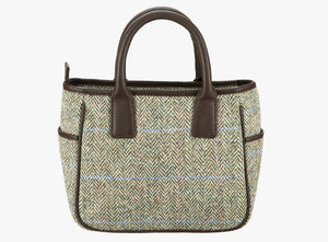 This is the reverse of the Harris Tweed handheld bag in heath. The colour is a cream and brown herringbone with a pink and blue overcheck . It has a pocket on each side of the bag trimmed with brown leather. It also has short brown leather handles.