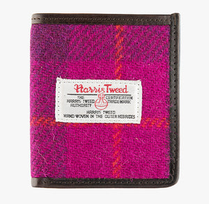 This is the front of the Harris Tweed card holder in pink check, it is a dark pink and bright pink check with an orange overcheck.  It is trimmed in brown leather. This card and note holder has room for 6 cards and a slot to hold your banknotes. It has a rectangular Harris Tweed logo on the front.  