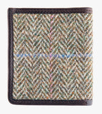 This is the rear view of the Harris Tweed card and note holder in pastel check, it is a cream and brown small herringbone design with a blue and pink overcheck.  It is trimmed in brown leather.