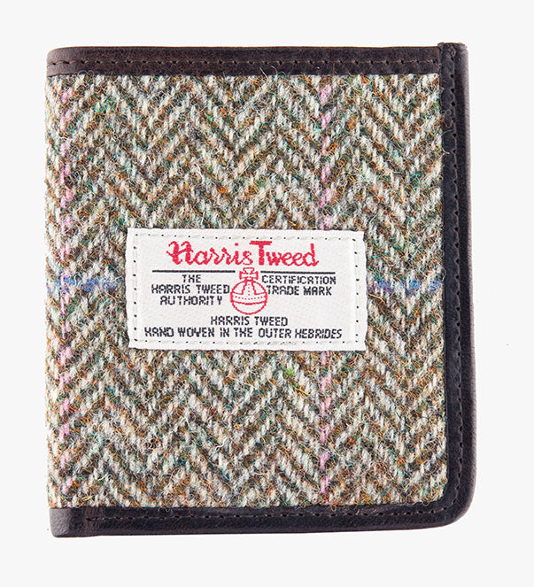 This is the front of the Harris Tweed card holder in pastel check, it is a cream and brown small herringbone design with a blue and pink overcheck.  It is trimmed in brown leather. This card and note holder has room for 6 cards and a slot to hold your banknotes. It has a rectangular Harris Tweed logo on the front.  