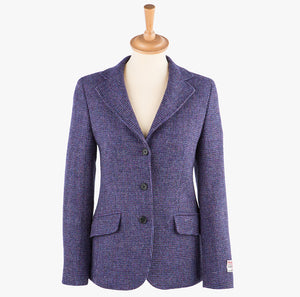 Harris Tweed ladies jacket in violet the colour is a purple. It has three buttons and two pockets.