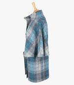This is the side view of the belted cape in Lavender, the colour is blue, lilac and grey check, with a purple and red overcheck. You can see the collar stood up and the sleeves of the cape which come mid-way down the arm. It has two pockets and ties at the waist for a neat silhouette.