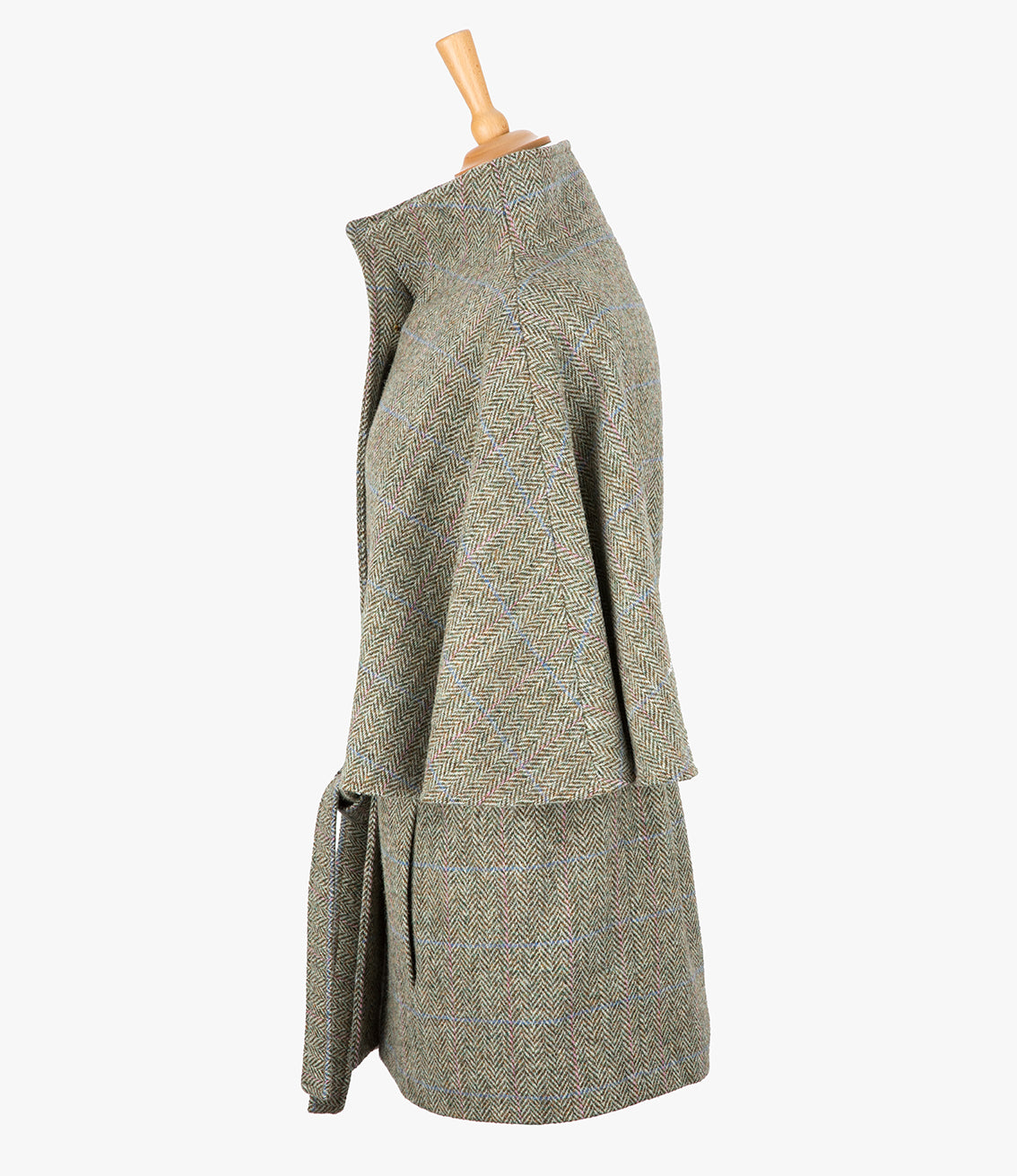 This is the side view of the belted cape in pastel check, the colour is cream and brown herringbone with a pink and blue overcheck. You can see the collar stood up and the sleeves of the cape which come mid-way down the arm. It has two pockets and ties at the waist for a neat silhouette.
