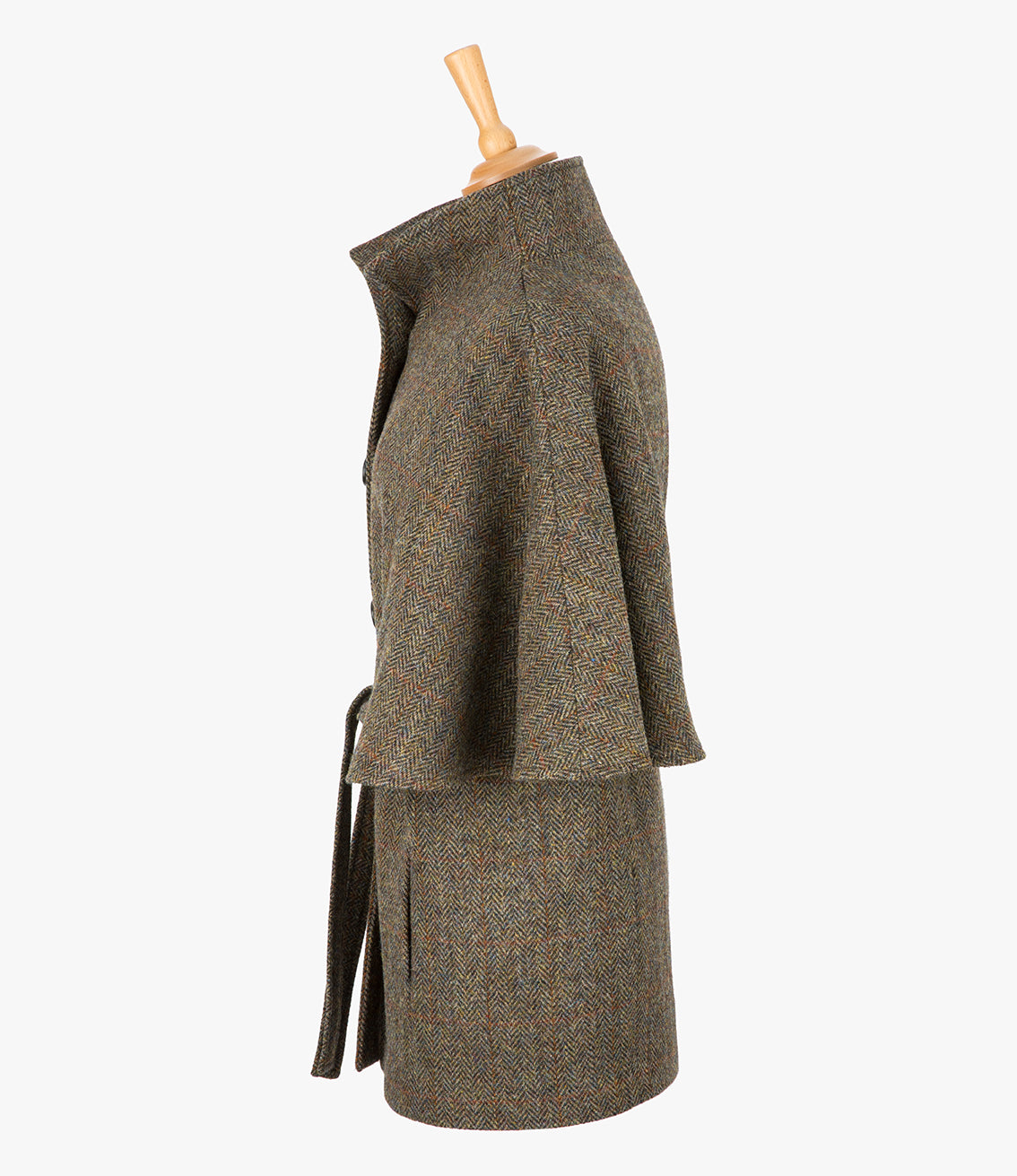 This is the side view of the belted cape in Brown herringbone. You can see the collar stood up and the sleeves of the cape which come mid-way down the arm. It has two pockets and ties at the waist for a neat silhouette.