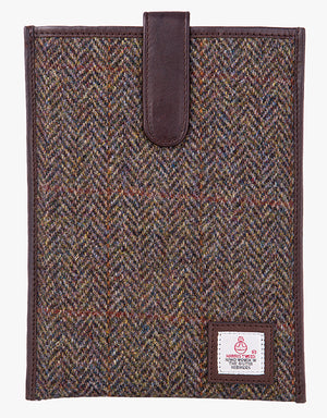 Harris Tweed tablet case in brown herringbone, trimmed with leather. This case has a magnetic closing and a small Harris Tweed logo at the bottom of the case.