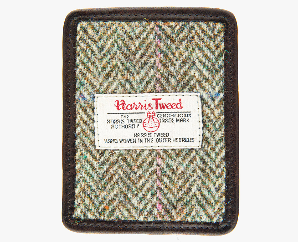 This is the front of the Harris Tweed card holder in pastel check, it is a cream and brown herringbone design with a pink and blue overcheck and is trimmed in brown leather. This card and note holder has room for 3 cards. It has a rectangular Harris Tweed logo on the front.  