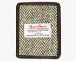 This is the front of the Harris Tweed card holder in pastel check, it is a cream and brown herringbone design with a pink and blue overcheck and is trimmed in brown leather. This card and note holder has room for 3 cards. It has a rectangular Harris Tweed logo on the front.  