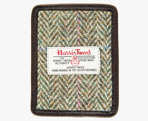 This is the front of the Harris Tweed card holder in pastel check, it is a cream and brown herringbone design with a pink and blue overcheck and is trimmed in brown leather. This card and note holder has room for 3 cards. It has a rectangular Harris Tweed logo on the front.  