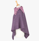 Side view the poncho in damson herringbone. It drops over the head and drapes gently over the shoulders. It comes mid-way down the arms and finishes at a point at the front. It has a contrasting folded collar in light pink with 3 Celtic buttons in silver.