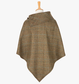 Rear view of the Earth poncho, this drops over the head and drapes gently over the shoulders. It comes mid-way down the arms and finishes at a point at the back. The colour is  brown with a black, brown and blue overcheck. It has a folded collar with 3 button holes on the left.