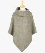 Harris Tweed poncho in pastel check, it has a folded over cowl collar with 3 Celtic buttons detail. 