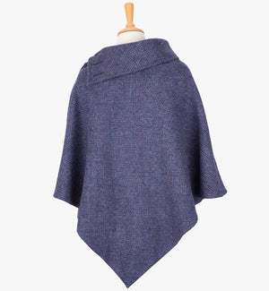 Rear view of the violet poncho, this drops over the head and drapes gently over the shoulders. It comes mid-way down the arms and finishes at a point at the back. The colour is a purple. It has a folded collar with 3 button holes on the left.