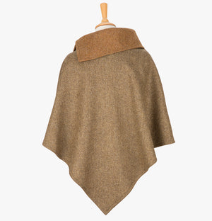 Rear view of the Earth poncho, this drops over the head and drapes gently over the shoulders. It comes mid-way down the arms and finishes at a point at the back. The colour is Camel herringbone with a contrasting collar in plain camel. It has a folded collar with 3 button holes on the left.