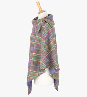 Side view the poncho in Multi check. It drops over the head and drapes gently over the shoulders. It comes mid-way down the arms and finishes at a point at the front. The colour is Multicoloured check.  It has a folded collar with 3 Celtic buttons in silver.