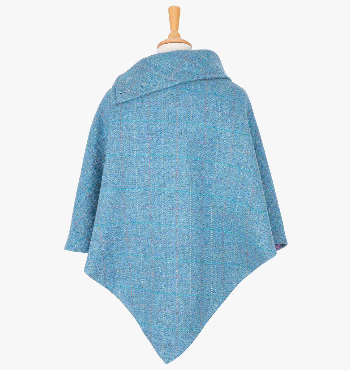 Rear view of the sky poncho, this drops over the head and drapes gently over the shoulders. It comes mid-way down the arms and finishes at a point at the back.. It has a folded collar with 3 button holes on the left.