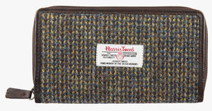Harris Tweed purse in Heath with a brown leather trim. It also has a Harris tweed logo on the front