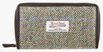 Harris Tweed purse in pastel herringbone with a brown leather trim. It also has a Harris tweed logo on the front