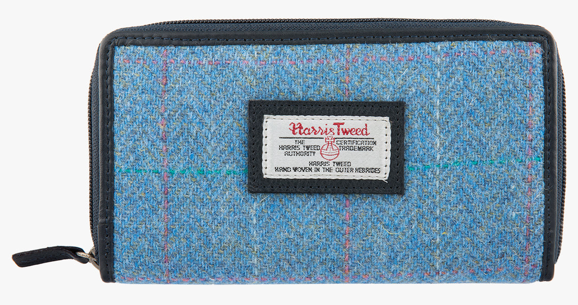 Harris Tweed purse in Sky blue with a navy leather trim.  It also has a Harris tweed logo on the front.