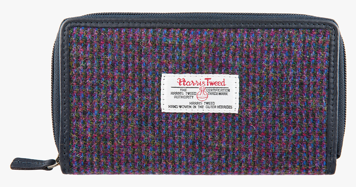 Harris Tweed purse in purple with a navy leather trim.  It also has a Harris tweed logo on the front.