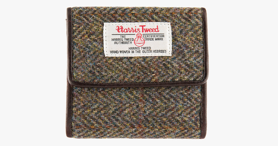 Harris Tweed purse in Brown herringbone with a brown leather trim.  It also has a Harris tweed logo on the front.