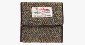 Harris Tweed purse in Brown herringbone with a brown leather trim.  It also has a Harris tweed logo on the front.