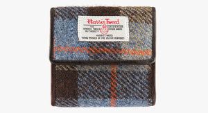 Harris Tweed purse in Camel check with a brown leather trim.  It also has a Harris tweed logo on the front.