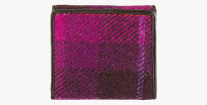 Harris Tweed purse in cerise with a brown leather trim.  It also has a Harris tweed logo on the front.