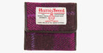 Harris Tweed purse in cerise with a brown leather trim.  It also has a Harris tweed logo on the front.
