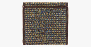 Harris Tweed purse in Heath nwith a brown leather trim.  It also has a Harris tweed logo on the front.