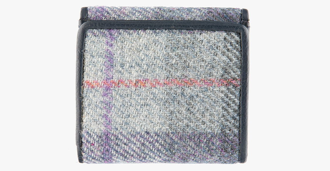 Rear view of Harris Tweed purse in lavender with a navy leather trim. 