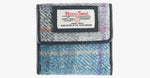 Harris Tweed purse in lavender with a navy leather trim.  It also has a Harris tweed logo on the front.