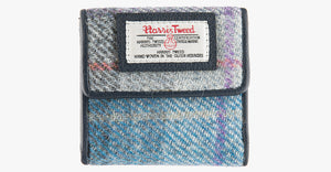 Harris Tweed purse in lavender with a navy leather trim.  It also has a Harris tweed logo on the front.
