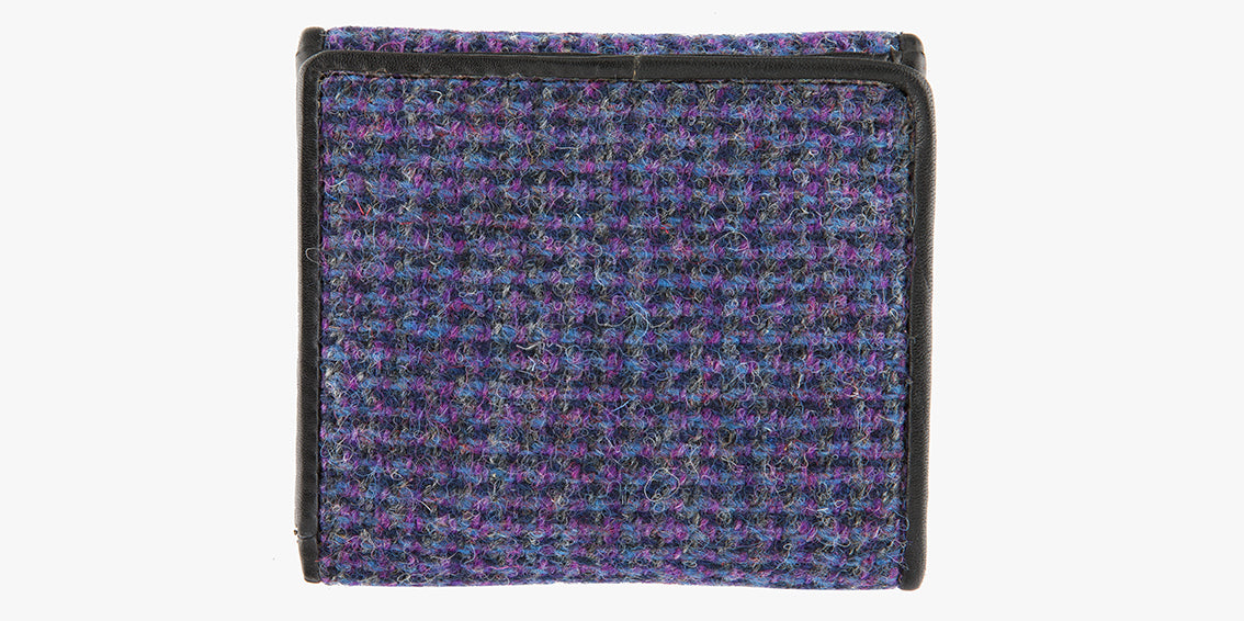 Rear view of Harris Tweed purse in Violet with a black leather trim. 
