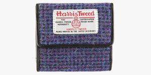 Harris Tweed purse in violet with a brown leather trim.  It also has a Harris tweed logo on the front.