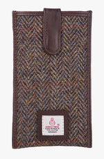 Harris Tweed phone case in pastel herringbone trimmed with leather. This case has a magnetic closing and a small Harris Tweed logo at the bottom of the case.