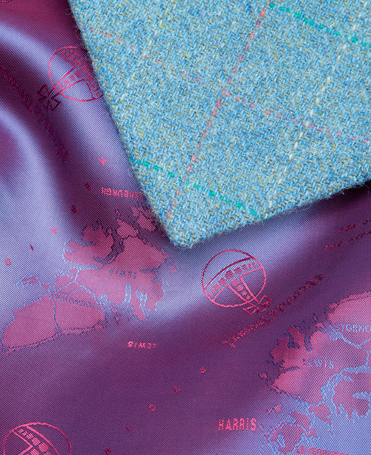 Inside view of the Jacket lining, purple shiny, silky lining with the Harris Tweed orb and the Isle of Harris woven into the fabric.